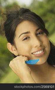 Portrait of a teenage girl holding a table knife