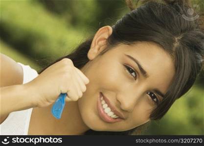 Portrait of a teenage girl holding a table knife