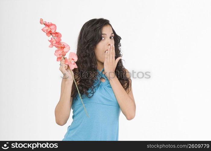 Portrait of a teenage girl holding flowers and looking worried