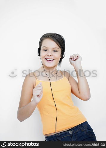 Portrait of a teenage girl listening to music and dancing