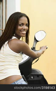 Portrait of a teenage girl on a moped