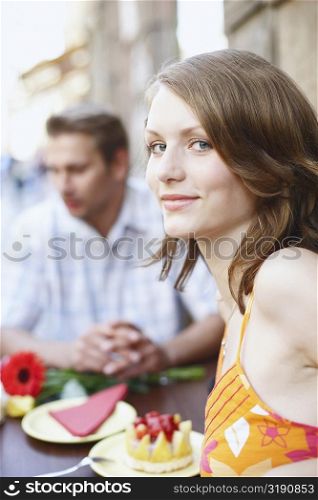 Portrait of a teenage girl seated at a table in a restaurant