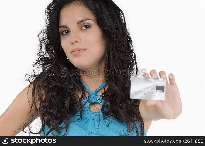 Portrait of a teenage girl showing a credit card