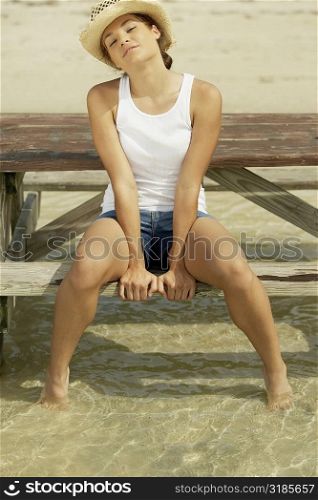 Portrait of a teenage girl sitting on a bench