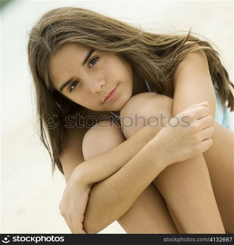 Portrait of a teenage girl sitting on the beach