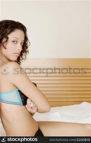 Portrait of a teenage girl sitting with her arms crossed
