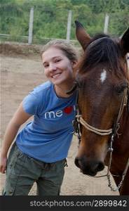 Portrait of a teenage girl standing beside a horse, Sayulita, Nayarit, Mexico