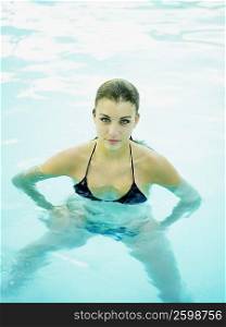 Portrait of a teenage girl standing in a swimming pool