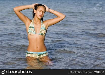 Portrait of a teenage girl standing in water in the sea