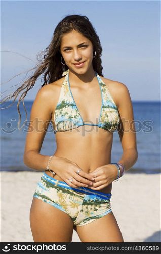 Portrait of a teenage girl standing on the beach