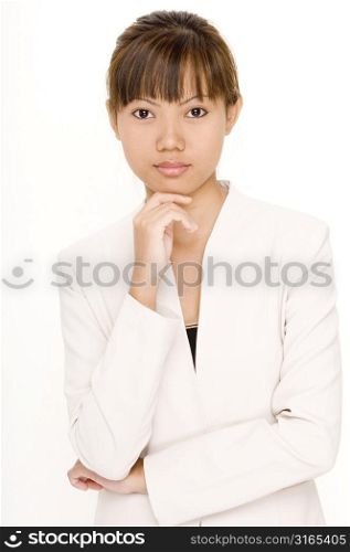 Portrait of a teenage girl standing with her hand on her chin