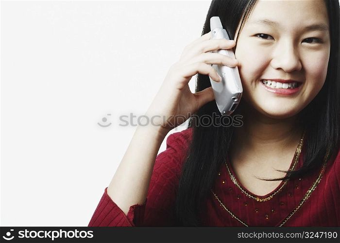 Portrait of a teenage girl talking on a mobile phone