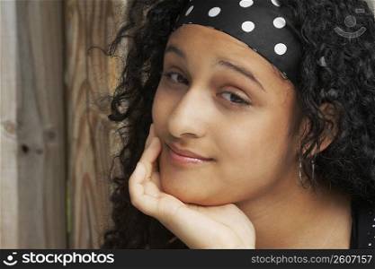 Portrait of a teenage girl thinking with her hand on her chin