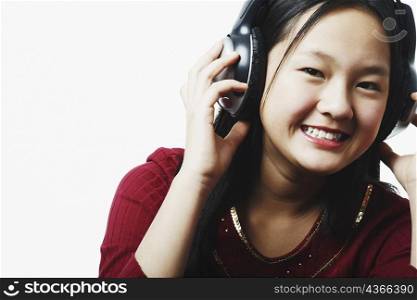 Portrait of a teenage girl wearing headphones listening to music