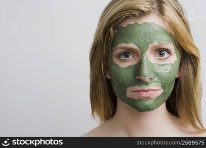 Portrait of a teenage girl with a facial mask