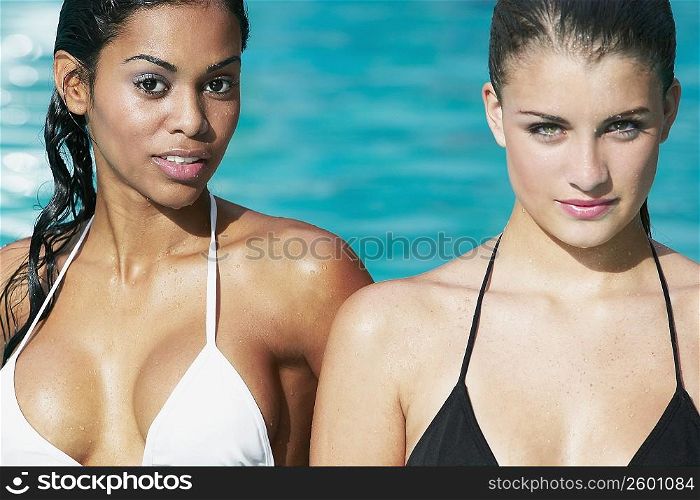 Portrait of a teenage girl with a young woman in a swimming pool
