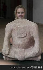 Portrait of a teenage girl with Mayan headless clay statue, Copan, Copan Ruinas, Honduras