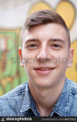 Portrait of a teenager rebellious man on a wall with graffiti background