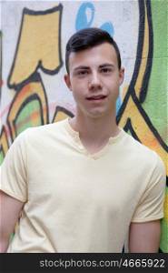 Portrait of a teenager rebellious man on a wall with graffiti background