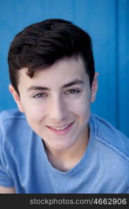 Portrait of a teenager rebellious man with a blue background