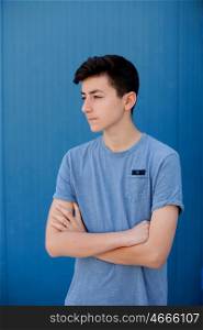 Portrait of a teenager rebellious man with a blue background