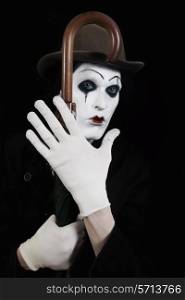 Portrait of a terrible mime holding a walking-stick in his hand