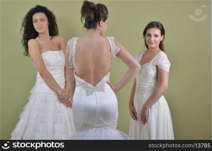 portrait of a three beautiful woman in wedding dress, bride and her friends bridesmaid