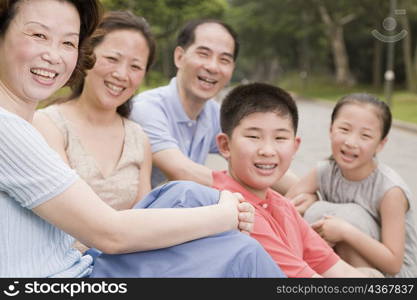 Portrait of a three generation family sitting together in a garden