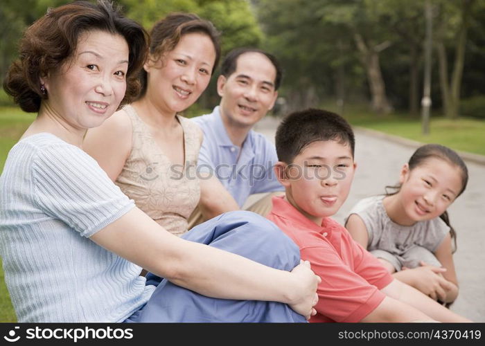Portrait of a three generation family sitting together in a garden