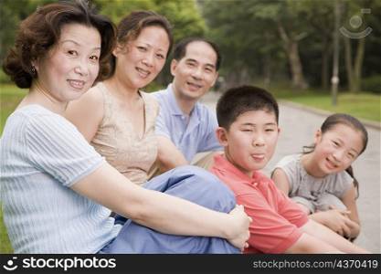 Portrait of a three generation family sitting together in a garden
