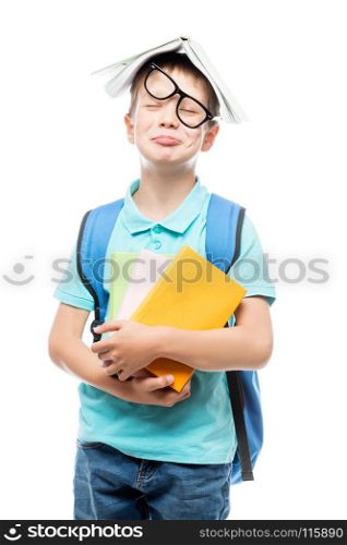 portrait of a tired schoolboy with books in the studio on a white background