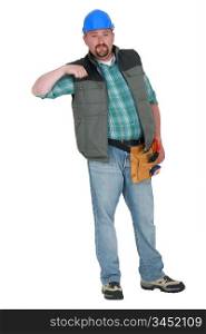 Portrait of a tradesman holding his arm up