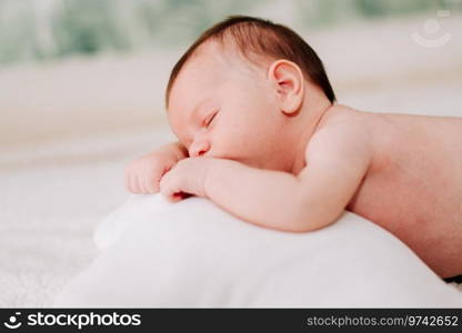 portrait of a two weeks old newborn asleep in studio lighting