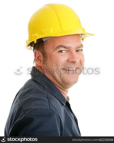 Portrait of a typical construction worker smiling, in a hardhat against a white background.