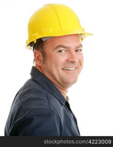 Portrait of a typical construction worker smiling, in a hardhat against a white background.