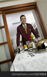 Portrait of a waiter serving food