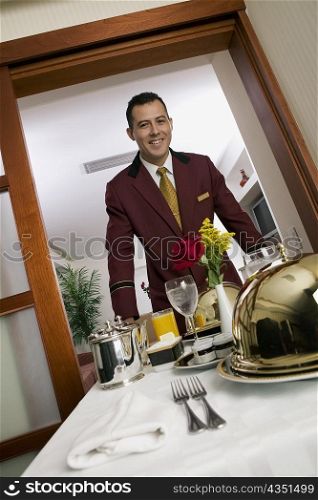 Portrait of a waiter serving food
