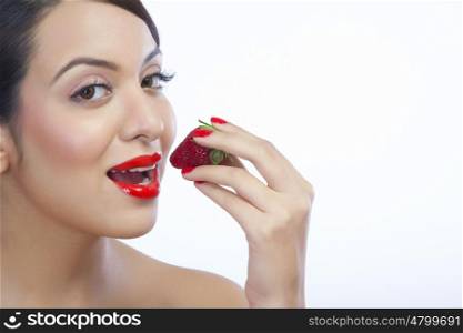 Portrait of a woman about to eat a strawberry