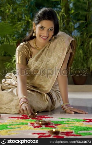 Portrait of a woman arranging diyas