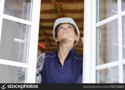 portrait of a woman checking window installation