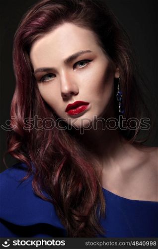 Portrait of a woman close-up. Red lips. Bright makeup.