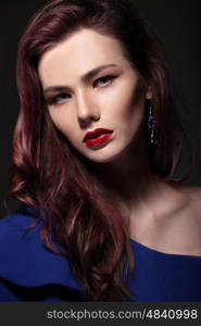 Portrait of a woman close-up. Red lips. Bright makeup.