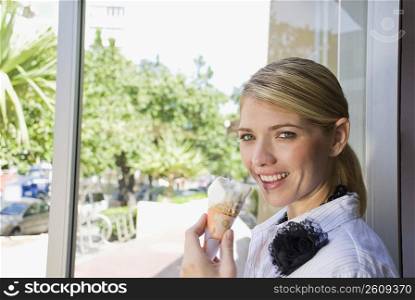 Portrait of a woman eating an ice cream