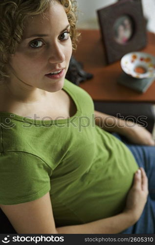 Portrait of a woman five months pregnant