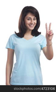 Portrait of a woman giving peace sign