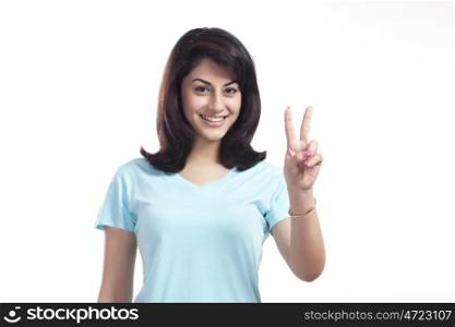 Portrait of a woman giving peace sign
