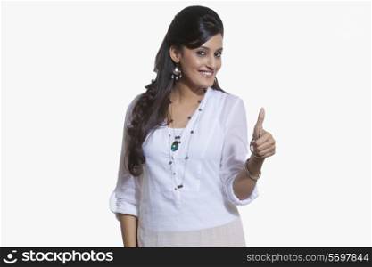 Portrait of a woman giving thumbs up sign