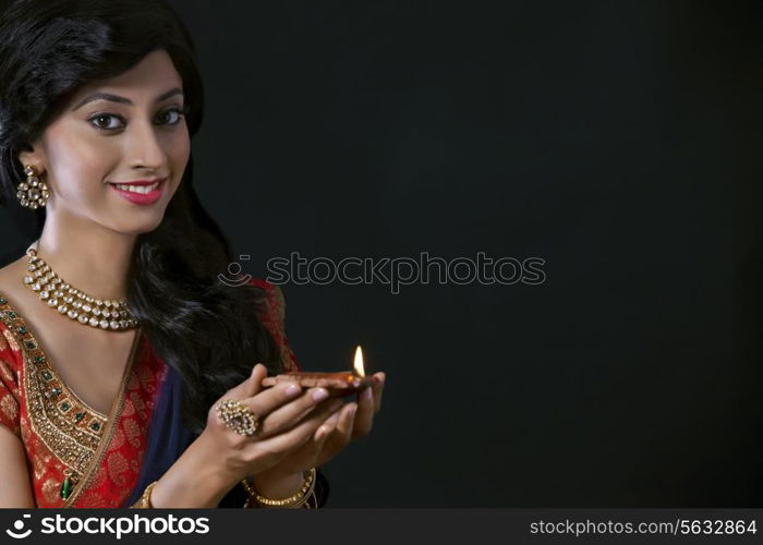 Portrait of a woman holding a diya