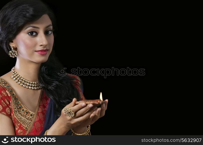 Portrait of a woman holding a diya