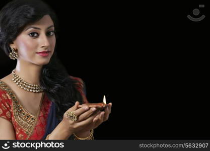 Portrait of a woman holding a diya